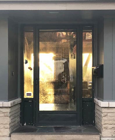 Old black full-glass entry door and two sidelights