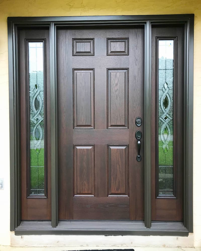 New 6-panel wood entry door with full-light sidelights with decorative glass