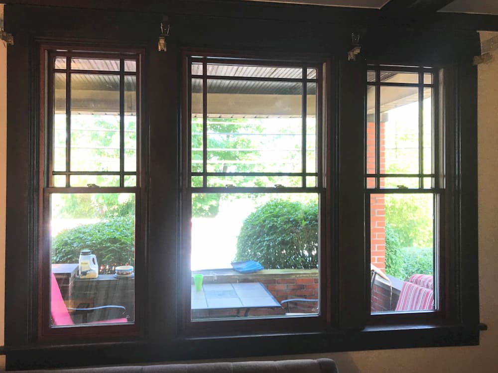 Interior view of black wood double-hung windows with top-sash prairie grille profiles