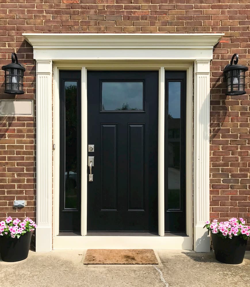 Exterior view of new fiberglass entry door and full-light sidelights on a red brick home