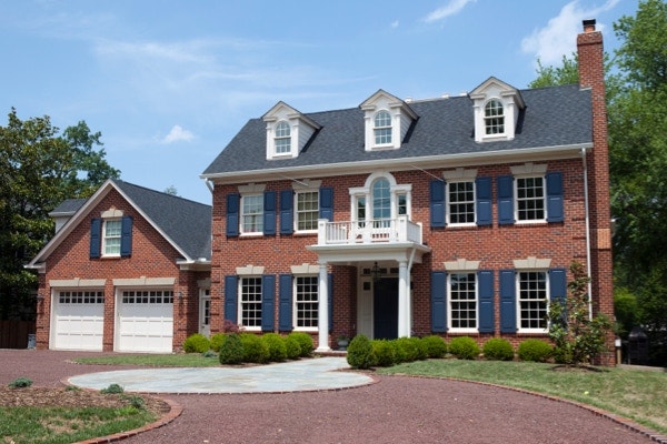 Brick Colonial home with double hung white windows