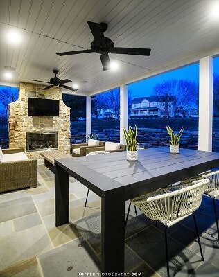 Covered patio with outdoor ceiling fan, fireplace and multiple seating areas