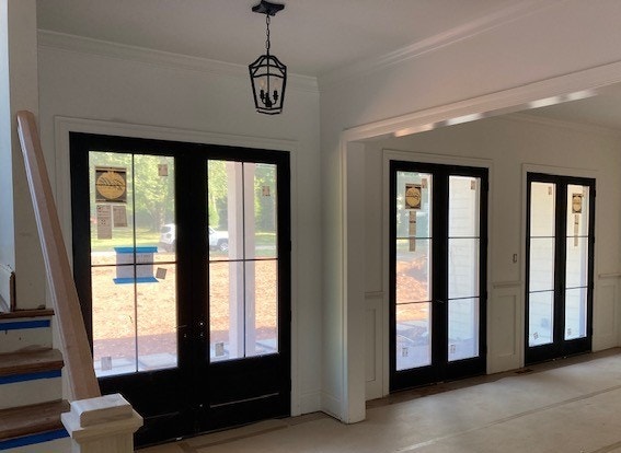 Interior view of three sets of black French doors