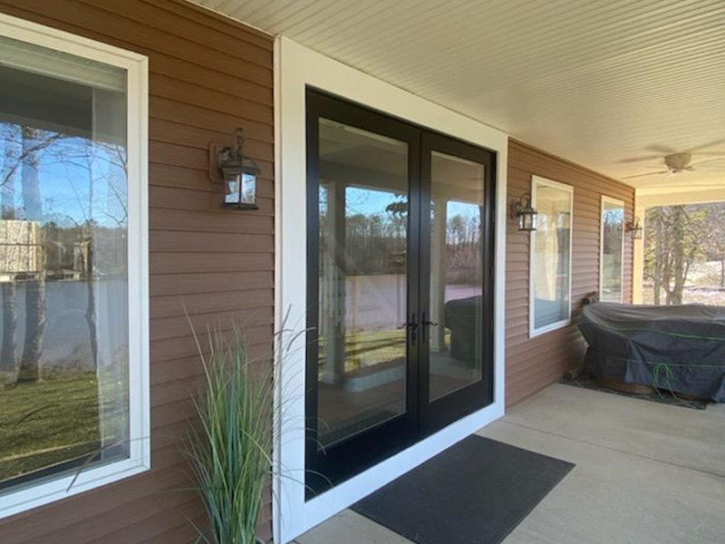 Dark wood hinged French patio doors on Mineral, VA, home exterior