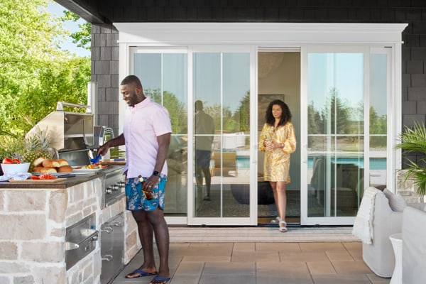 people enjoying an outdoor space with stunning sliding glass doors 
