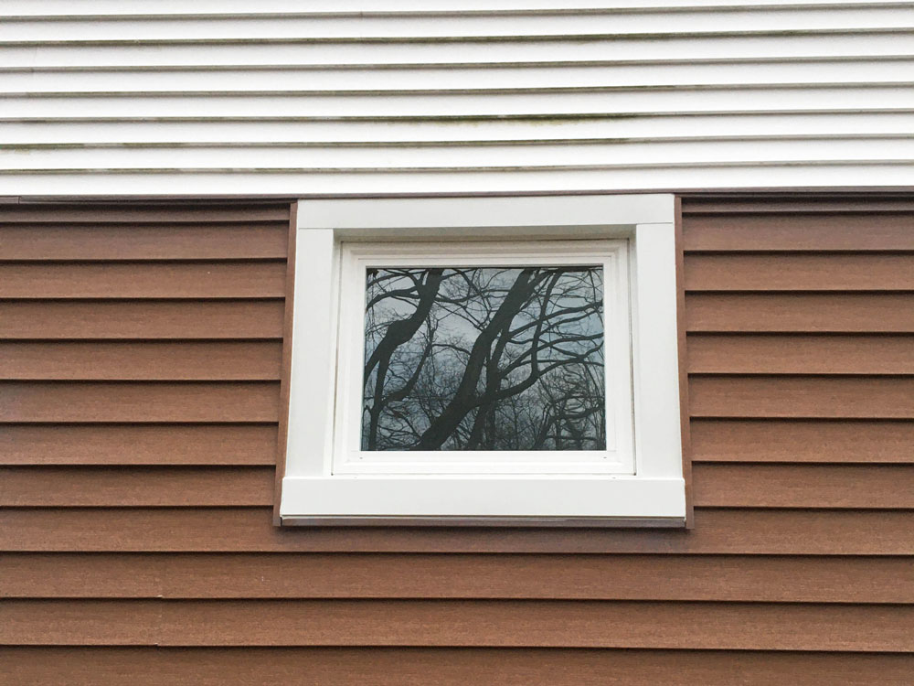 New Pella 250 Series vinyl awning window on Erie home