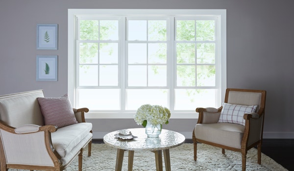 Vinyl windows white frame and gray wall in living room setting