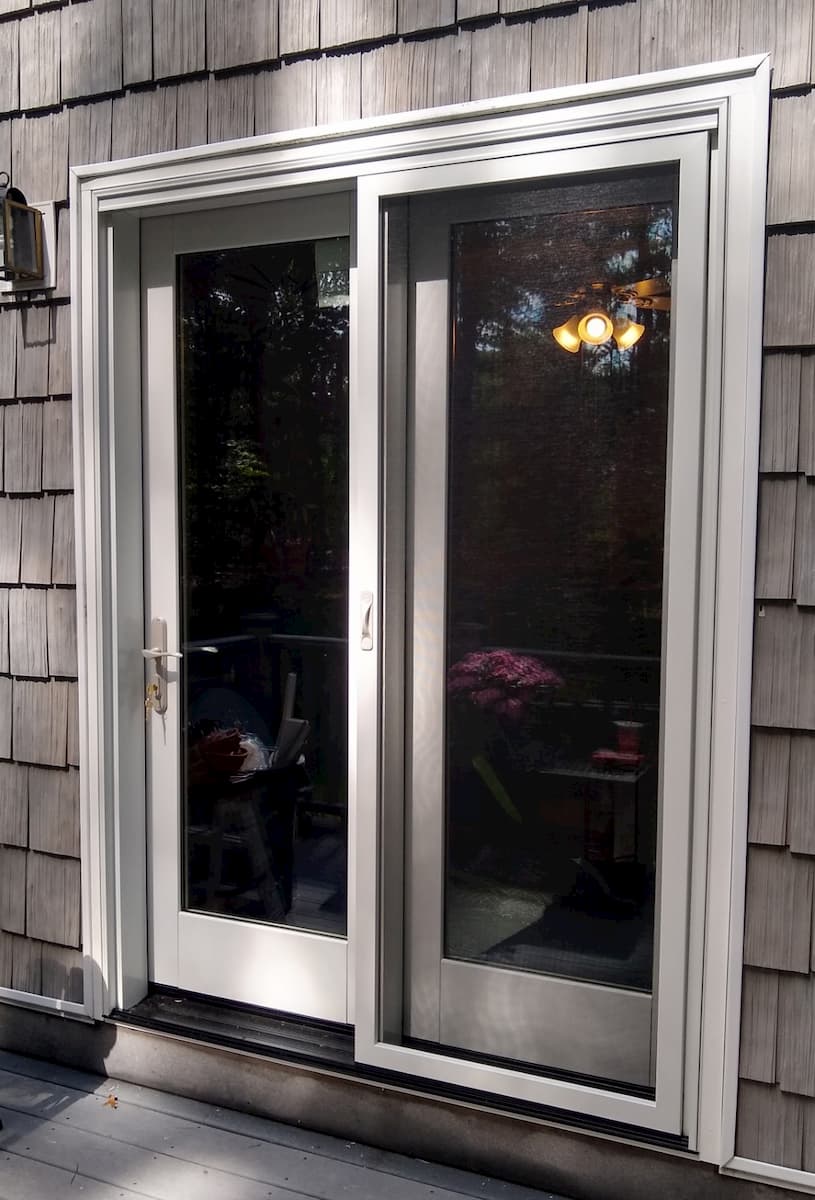 New wood French patio door on shingle-style home