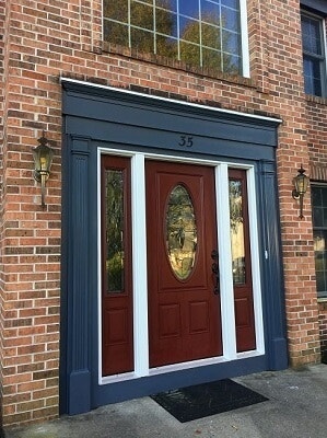 new fiberglass entry door with decorative side lights and trim