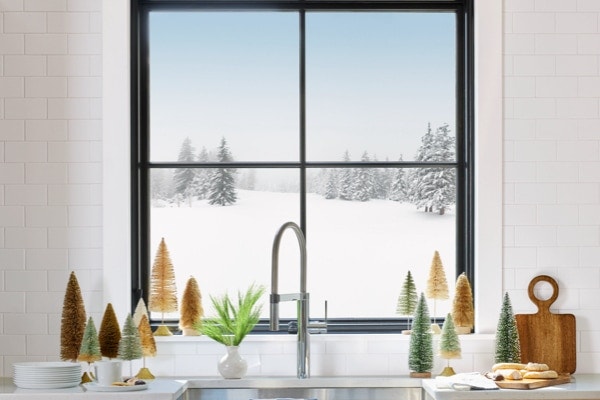 a snowy winter scene outside a kitchen window