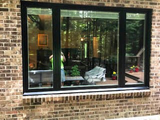 new black wood windows on a brick home