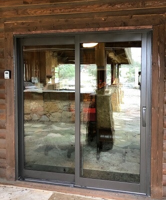 outside image of wimberley home with new wood sliding patio door