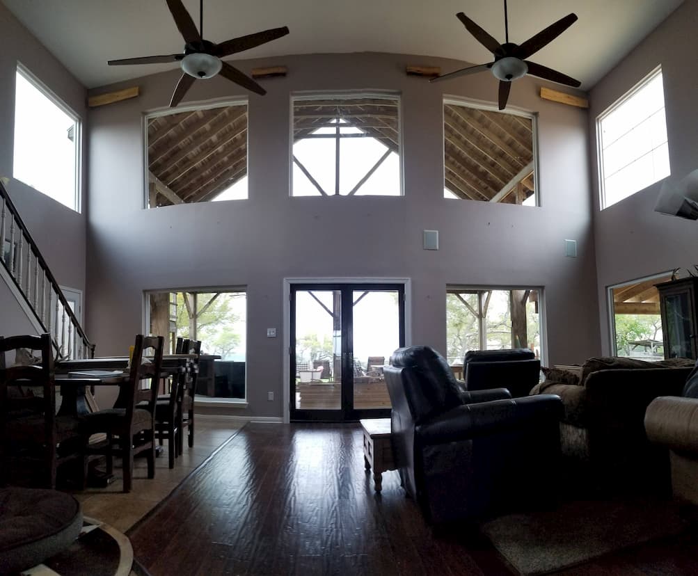 Interior view of living room with picture windows and double hinged patio doors