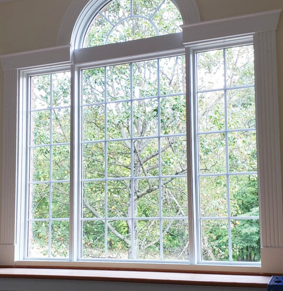 Wood picture windows with transom and traditional grille patterns