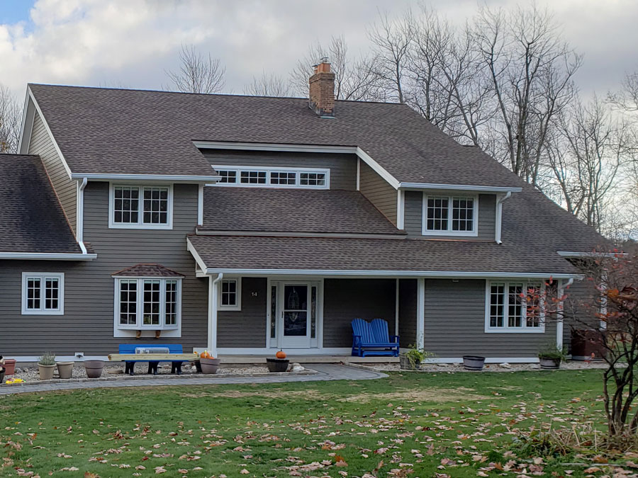 Front exterior view of West Granby, CT, home with new wood windows and a wood front door