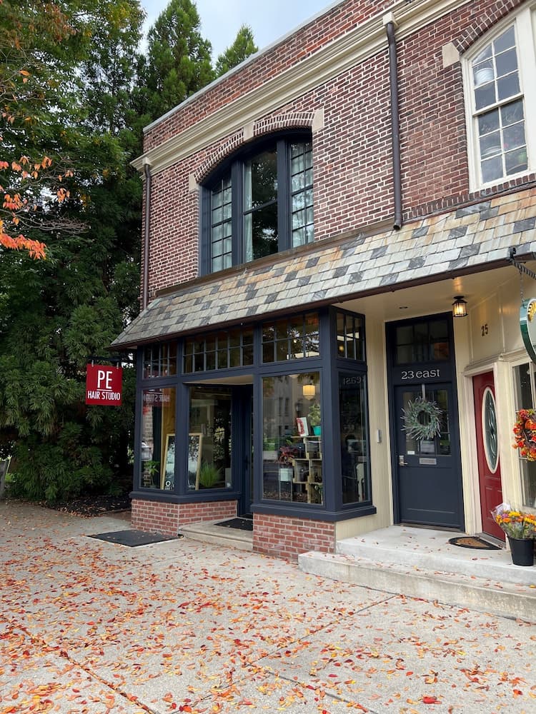 Historic storefront featuring new navy blue wood windows