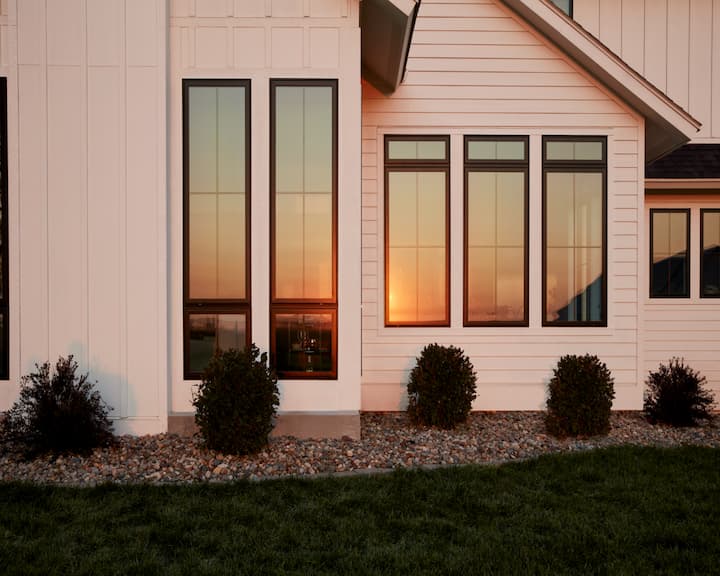 Black casement windows on white exterior home