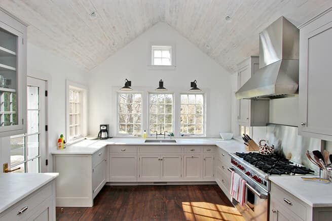 White kitchen with wood casement windows with traditional grille patterns