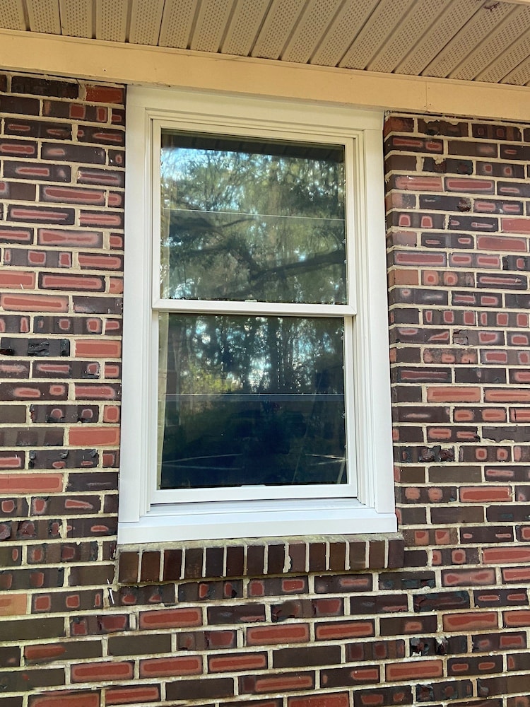 Brick home in Norfolk with new white wood double-hung window