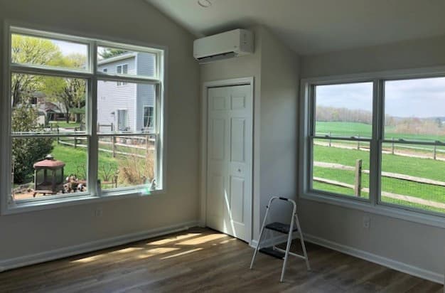 Interior view of room with new white wood double-hung windows