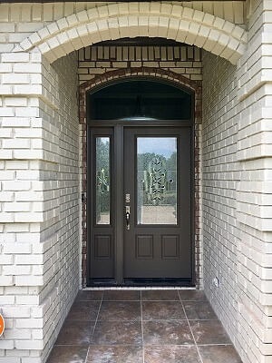 Brick home with entryway door with fiberglass