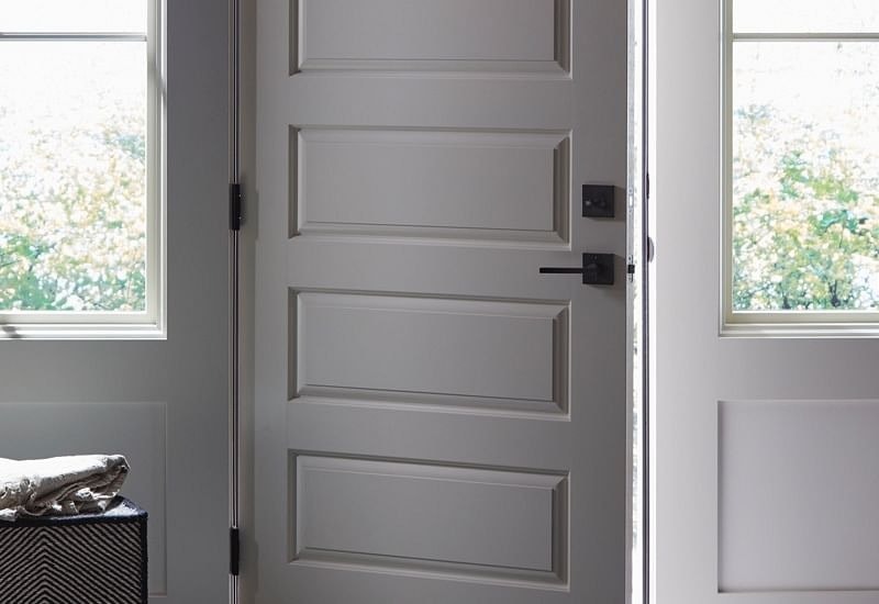 White door with black handle and lock