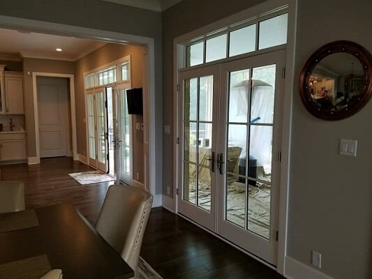 Interior view of closed white French hinged patio doors installed by Pella for newly constructed hom