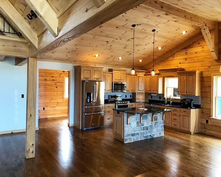 Log home kitchen featuring a combination of pella replacement windows.