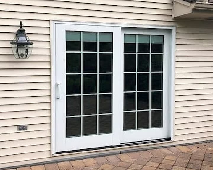 White sliding patio door with grilles