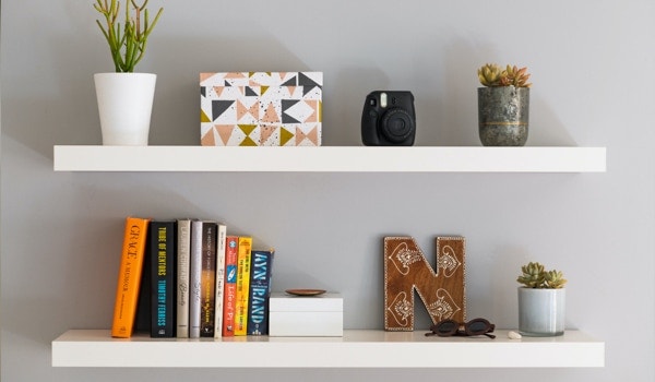 Floating shelves holding books and home decor