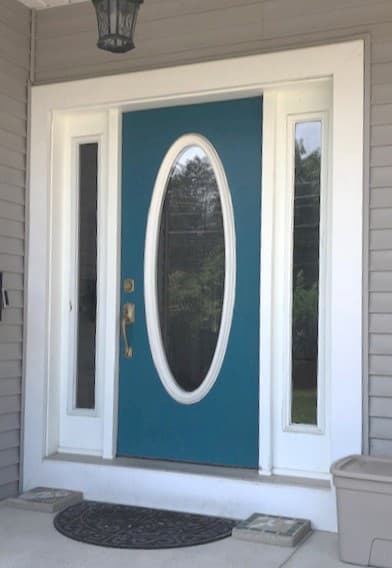 Old blue entry door with sidelights