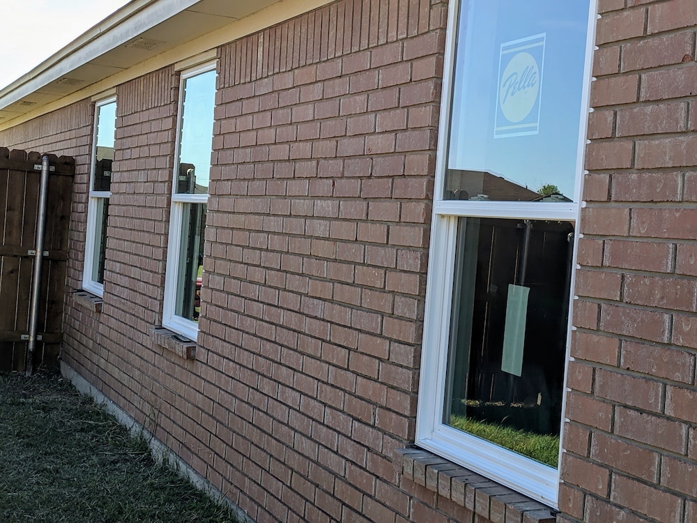 New vinyl single-hung windows with white frame being installed in Austin home