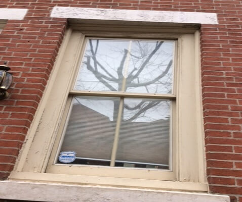 philadelphia home before with old windows, gets new wood double hung windows