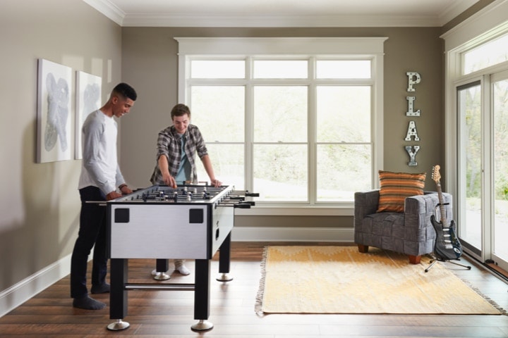 A beautiful play room with a foosball table and noise reducing windows