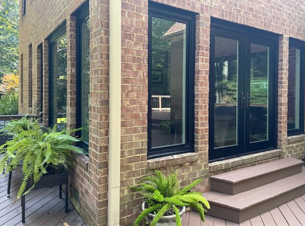 Brick home in Charlottesville, VA, with black frame windows