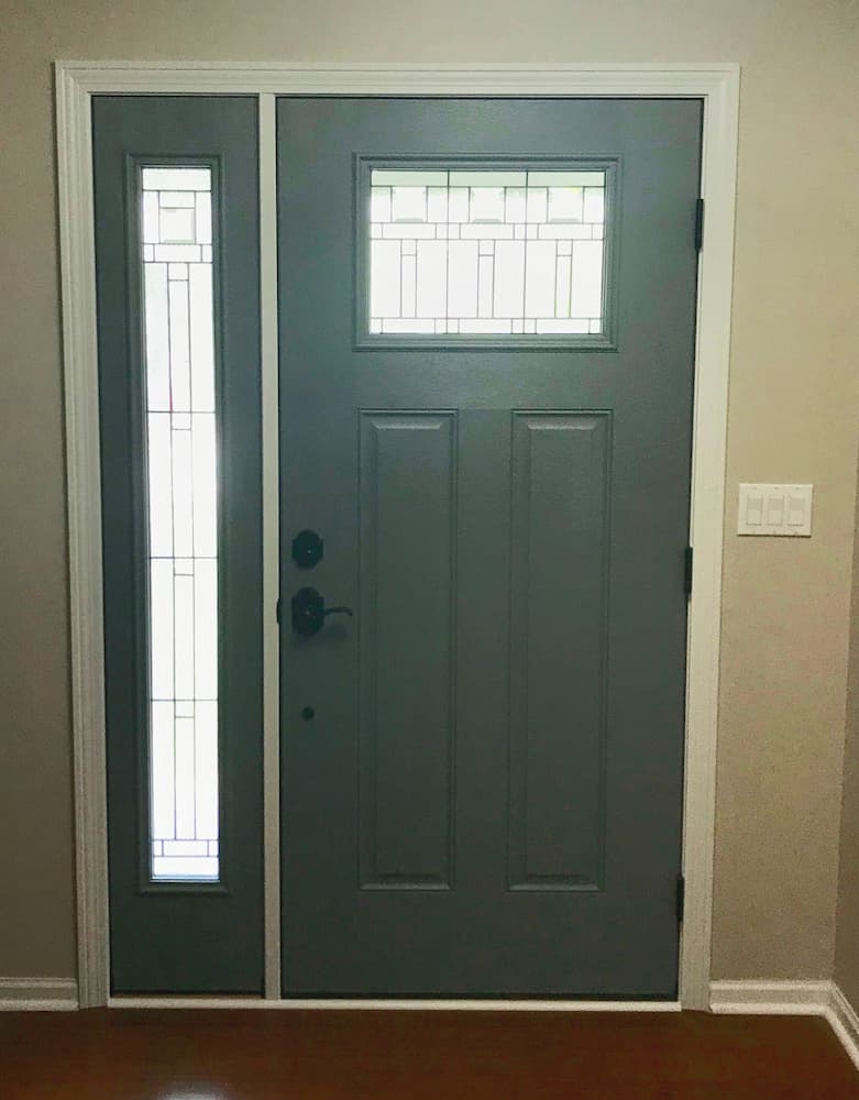 Interior view of new fiberglass entry door with decorative glass