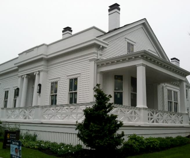 Greek Revival-style home with new white wood double-hung windows