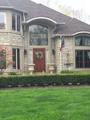 Stone home entryway with flag
