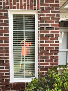 White vinyl double-hung window on red brick home