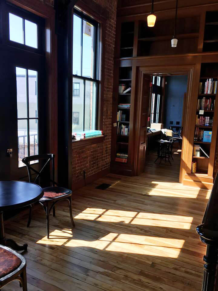 Sunlight comes through new wood windows on the storefront of Savoy Bookstore