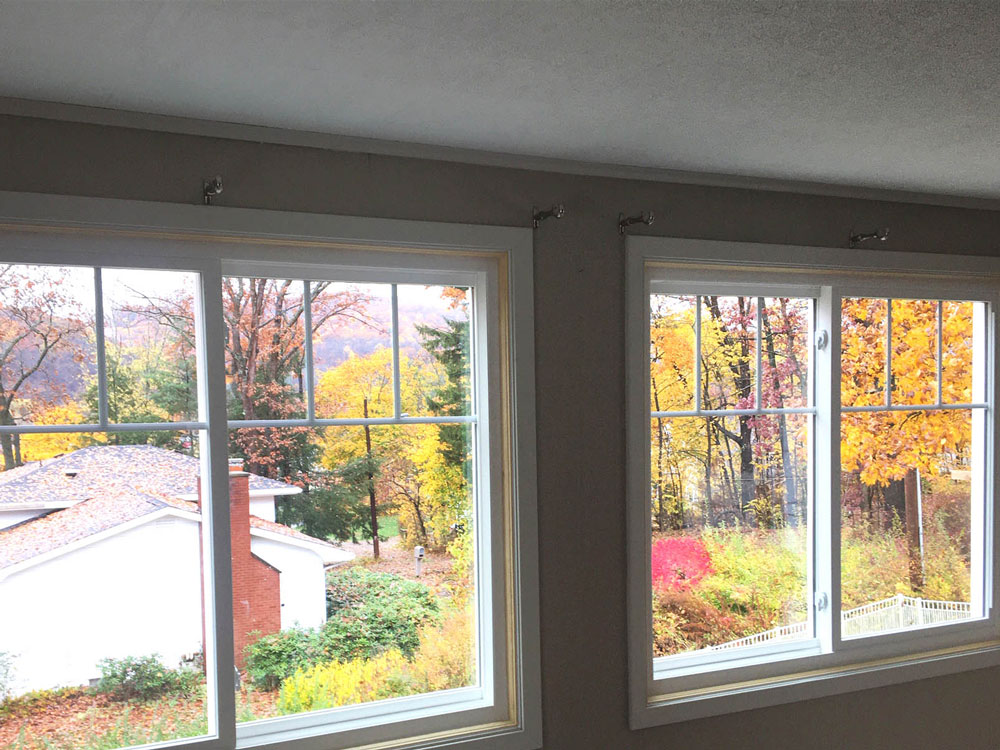 New side-by-side Pella 250 Series vinyl double-hung window on Conneaut Lake home