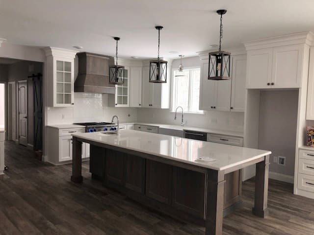New construction kitchen with large island and casement windows above the sink