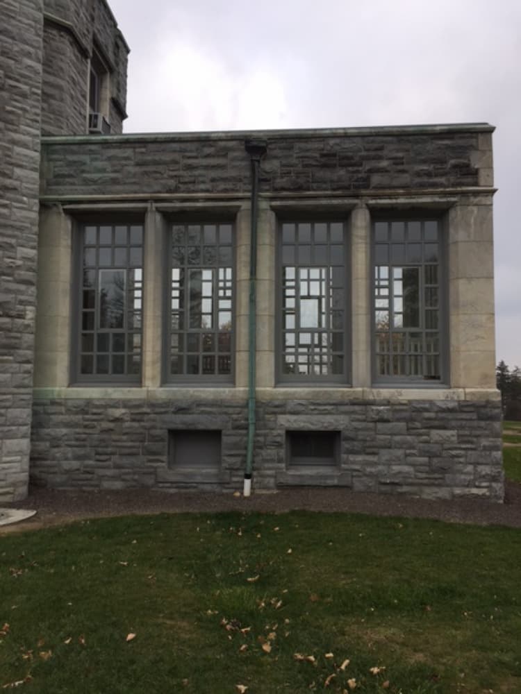 View of old, gray, traditional windows with grilles