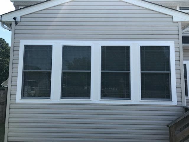 Exterior view of four fiberglass double-hung windows prairie-style grille patterns