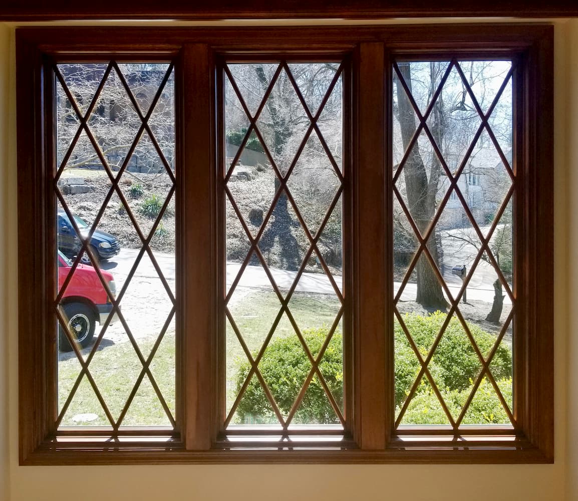 Interior view of new wood windows with diamond grille pattern