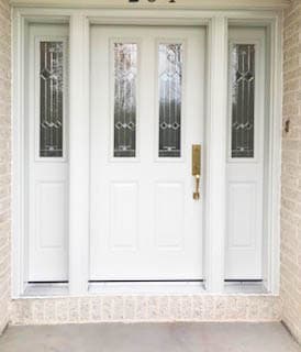 New white fiberglass entry door framed by two sidelights