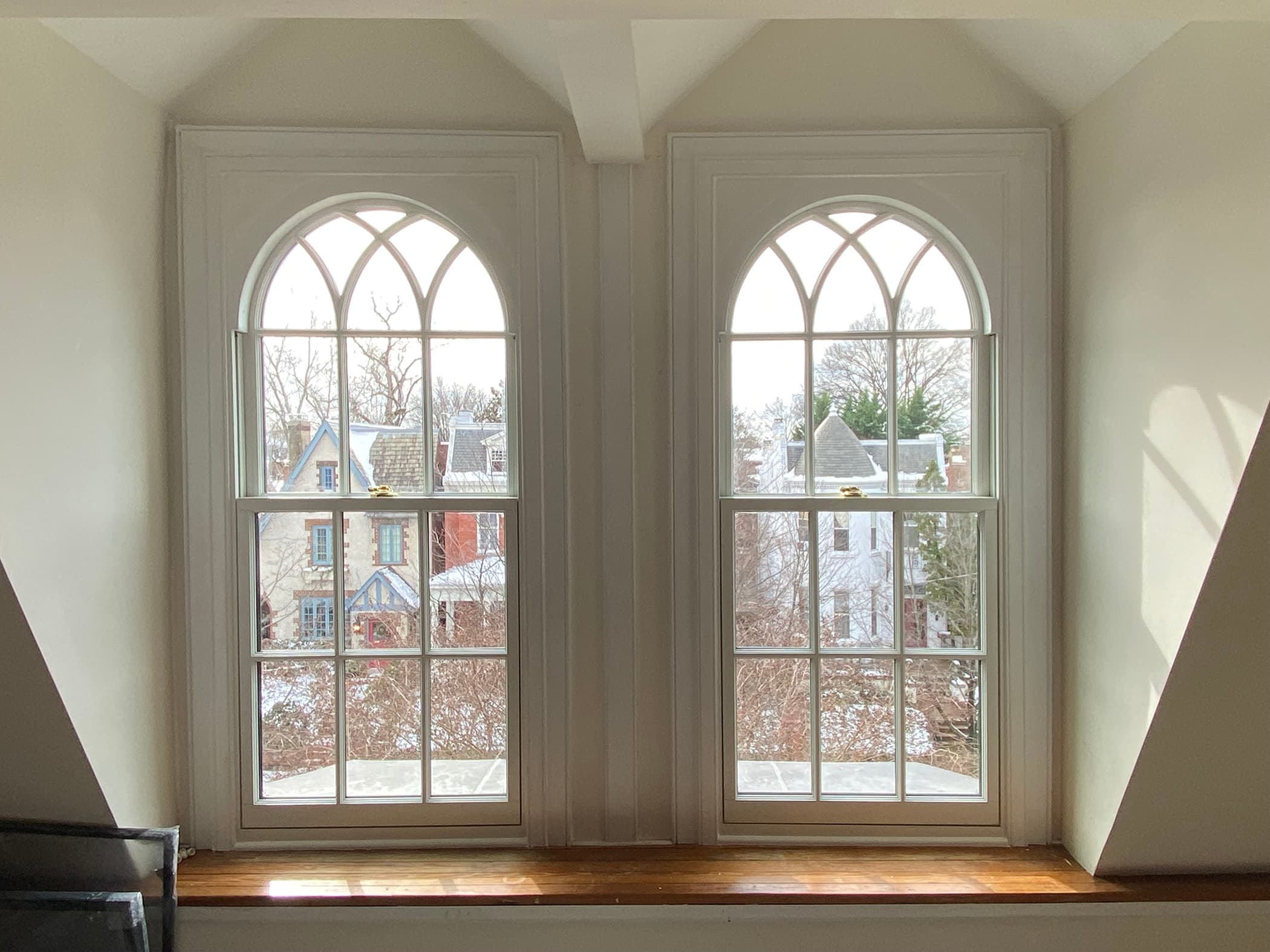 Interior of arched windows with gothic style grilles and custom framework