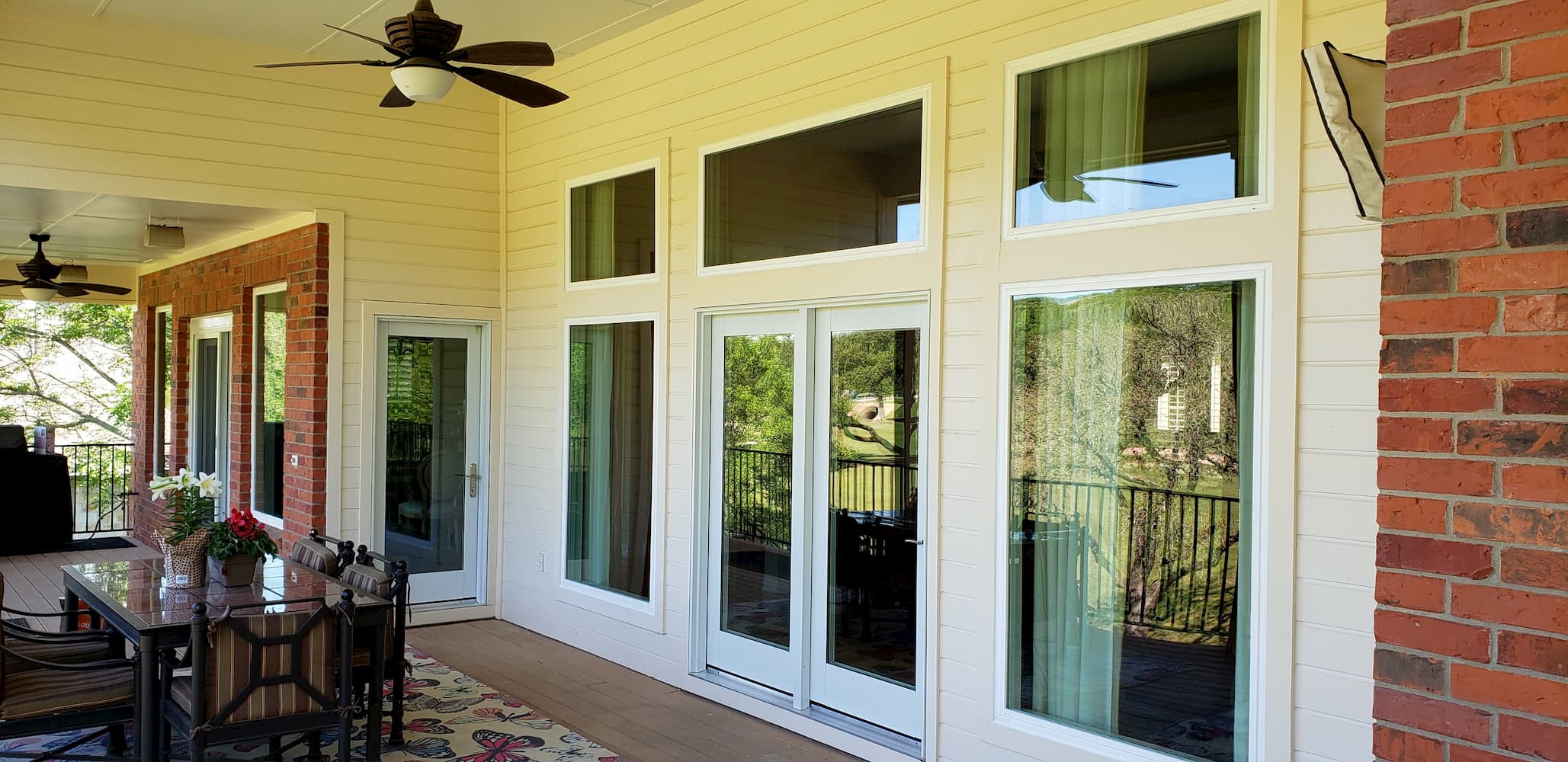 replacement four-panel sliding glass door on back deck of remodeled home