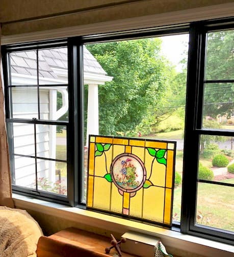 Interior view of black picture window with flanking single-hung windows
