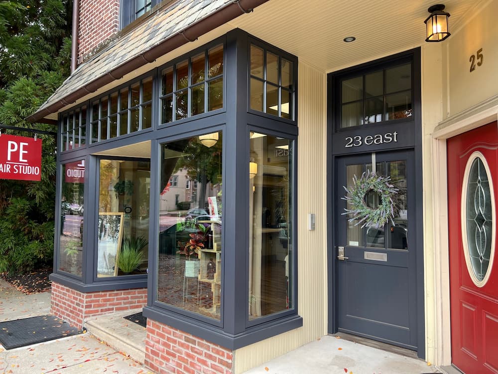 Historic storefront featuring new navy blue wood windows
